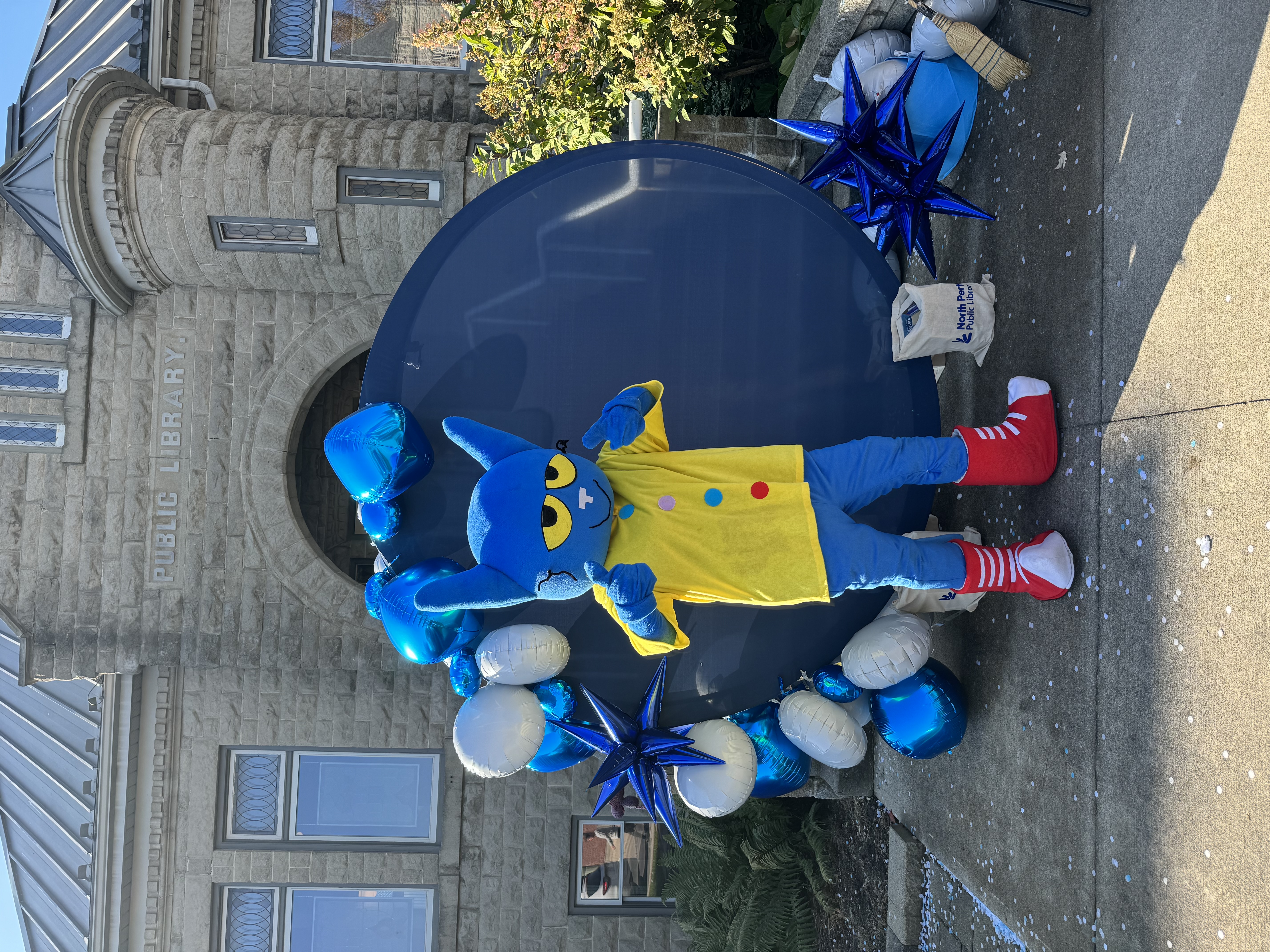 Mascot of Pete the Cat standing infront of North Perth Public Library