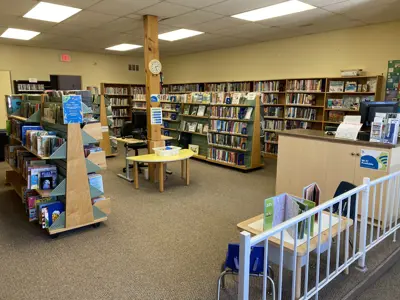 indoor shot of atwood library, showing numerous rows of shelves with small computer station